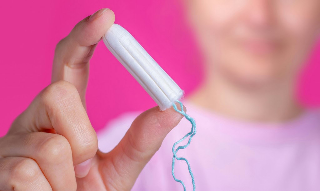 woman holding a tampon