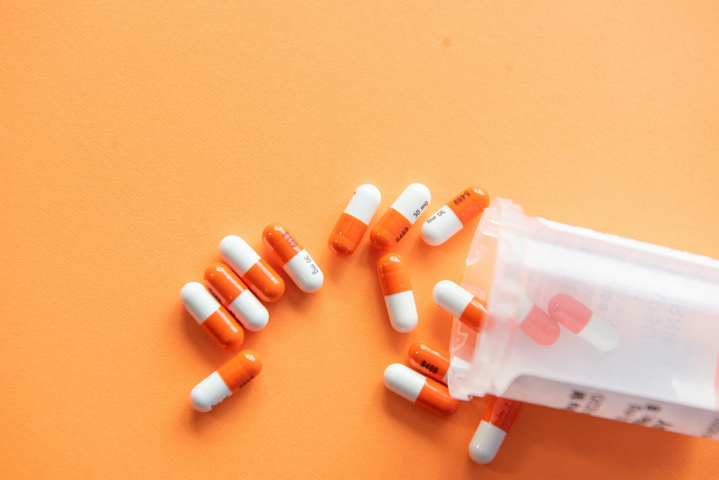 Antibiotics pills on an orange background
