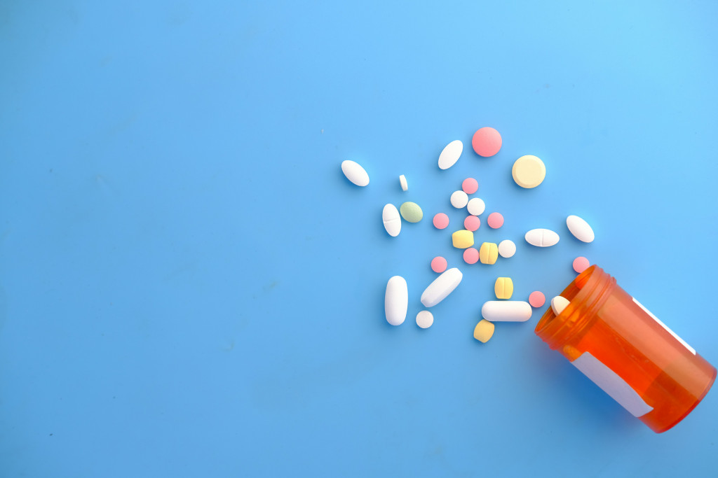 statin pills and pill tube on a blue background